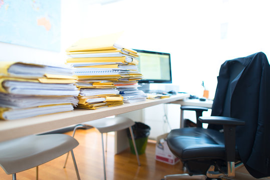 Bundles of documents and folders on commercial office desk