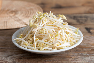 Bean sprouts on wooden background.