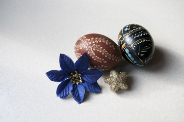 Fototapeta na wymiar Two Easter eggs and a flower