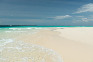 sandy beach and clear transparent sea wave