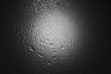 Water drops on dark wall and light, water drop for background and design.