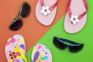 sunglasses with shoes on colorful paper background,summer holiday  background concept.