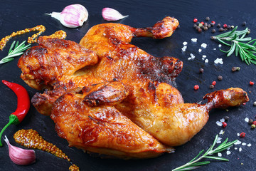 close-up of barbecued golden crispy chicken - obrazy, fototapety, plakaty