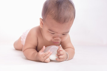 baby tries to suck milk from the bottle.