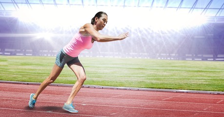 Obraz premium Full length of female athlete running on racing track