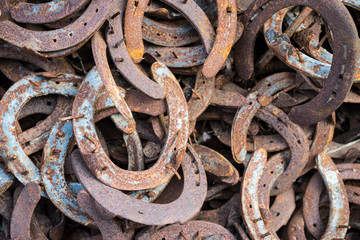 Large pile of rusty used Horseshoes