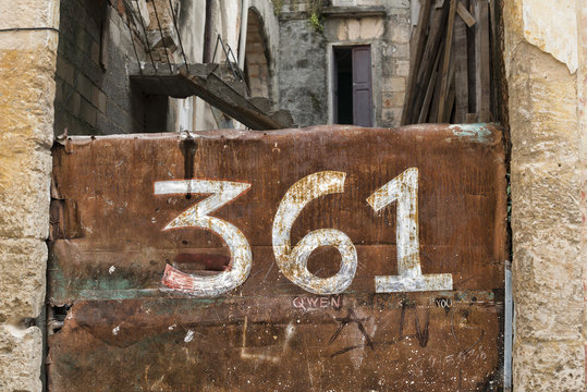 Rusty metal gate with 361 numbers