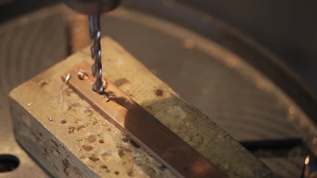 The machine drills platinum metal brass for electrical grounding. Drill a large size. Making security detail. Grounding is used to protect people when touching the metal parts of the equipment under