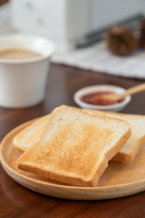 Fototapeta na wymiar Toast with coffee and jam on wood table.