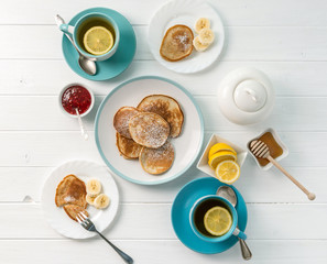 breakfast with pancakes, tea with lemon, topview