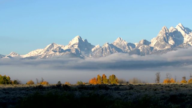 Pan of the Grand Teton mountains at sunrise during Fall