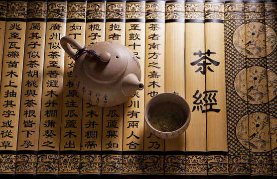 Traditional tea ceremony accessories, teapot and teacup with chinese poetry background