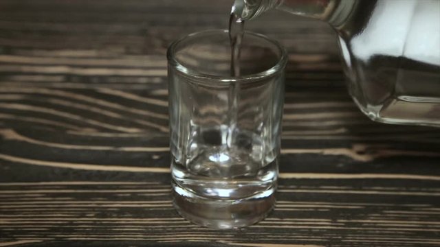 Poured a glass of vodka, close-up . Full hd video