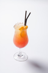 Tequila sunrise cocktail with ice on white background. Isolated