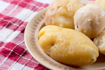 Cooked and peeled potatoes served on the plate