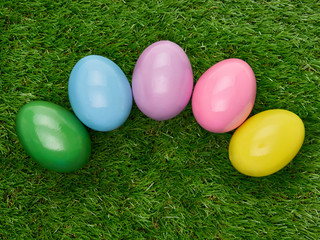 Fototapeta na wymiar Colourful painted decorated Easter Eggs on a green grass background.