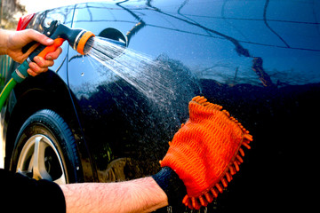 Car hand washing. A man washes his car.