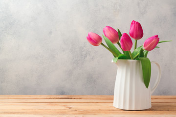 Tulip flowers bouquet on wooden table. Mothers day celebration concept
