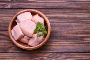 Raw chicken meat on wooden background
