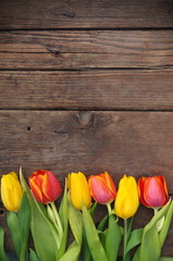 Tulips on wooden vintage background for Mother's Day .