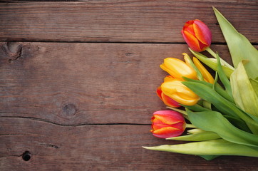 Tulips on wooden vintage background for Mother's Day .