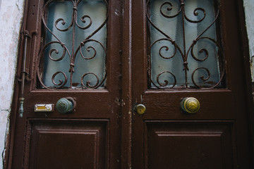 Old yellow, brown, red doors. Wood texture. Old shabby irradiated paint