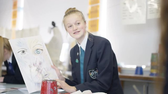  Group of teen girls in school art class, focus on 1 girl talking to her frien
