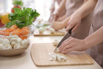 Woman cutting mushrooms at cooking classes