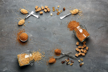 Composition with brown sugar on grey textured background