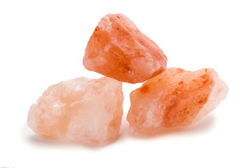 Closeup of Himalayan pink rock salt Isolated over white background - obrazy, fototapety, plakaty
