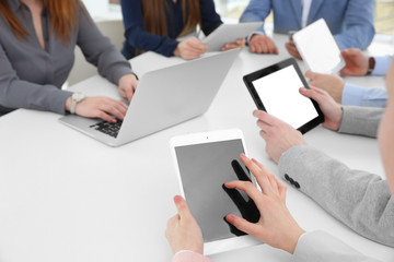 Team work concept. People sitting at table in office and using digital devices