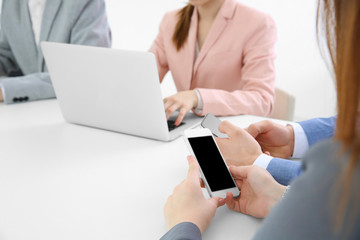 Team work concept. People sitting at table in office and using digital devices
