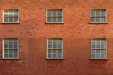 Fototapeta na wymiar Six windows on a brick building