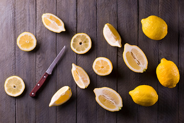 Fresh lemons on rustic wooden background.