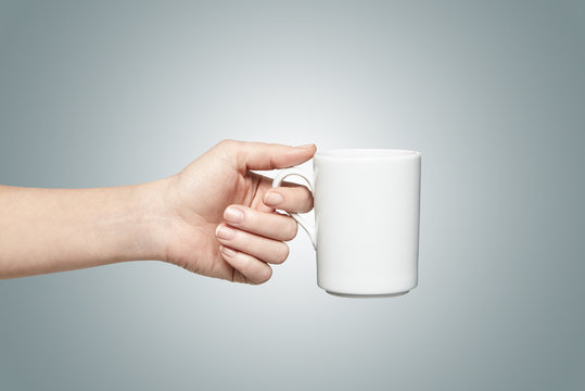 Woman holding a white mug