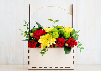Composition of fresh flowers on a white wooden background