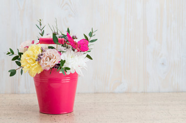 Composition of fresh flowers on a white wooden background