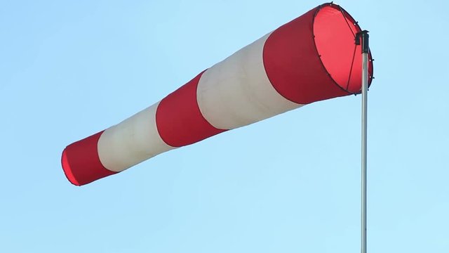 Cone-wind indicator against a blue sky. Rotation in motion