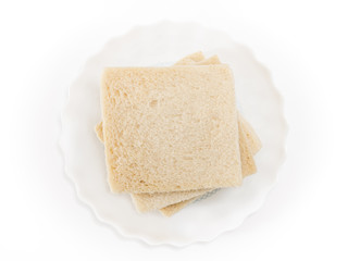White sandwich bread slices on plate, on white background.
