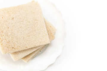 Fototapeta na wymiar White sandwich bread slices on plate, on white background.