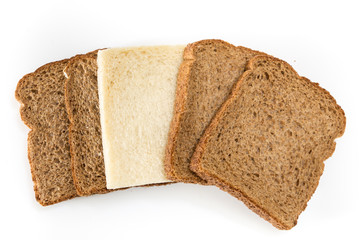 Whole grain sandwich bread slices with one white slice, on white background.