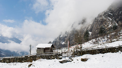 A hut in mid of snow covered mountains