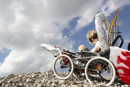 Boy sitting in a self-made rocket playing moon landing