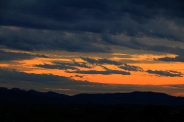 sunset in sky and rain cloud  beautiful colorful twilight time with mountain silhouette