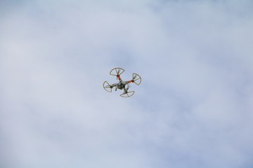 white drone motion hovering  with photo camera flying in  sky