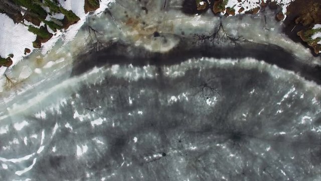 Flying view over a frozen forest in the mountains