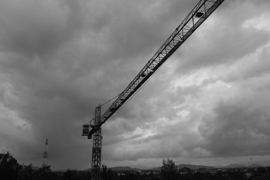 black and white image of  Tower crane silhouette construction with heavy industrial