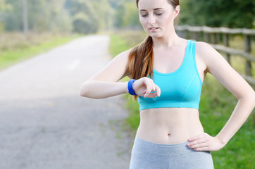 Woman using fitness bracelet