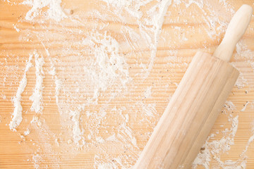 Messy floured wooden surface/ background and rolling pin.
