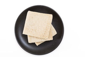 White sandwich bread slices on plate, on white background.